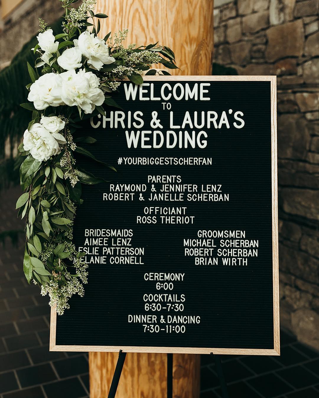 Wedding welcome sign with floral arrangement