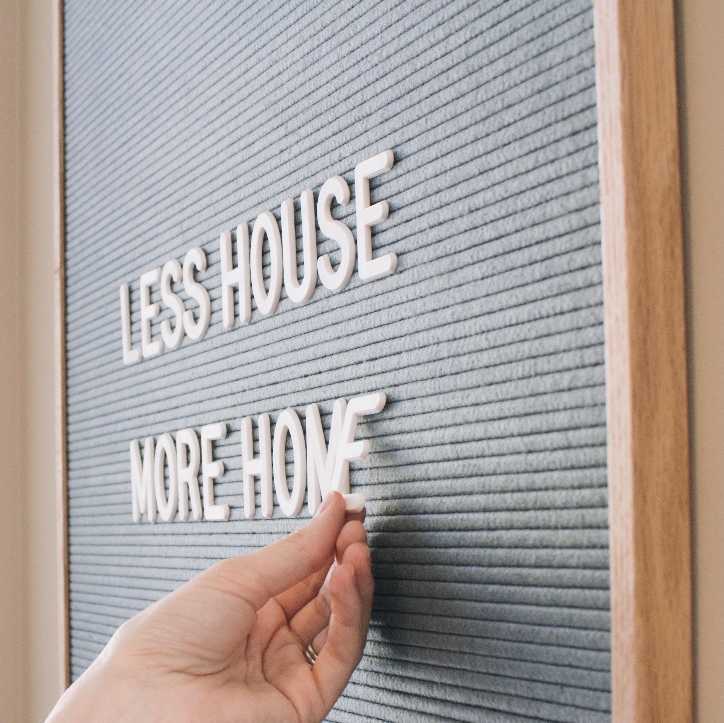 Hands carefully placing letters on a custom letter board